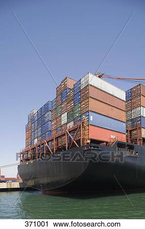 Stock Image - Cargo containers stacked on a ship. Fotosearch