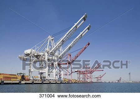 Cranes in a row at a commercial dock View Large Photo Image Picture - Cranes in a row at a commercial dock. Fotosearch