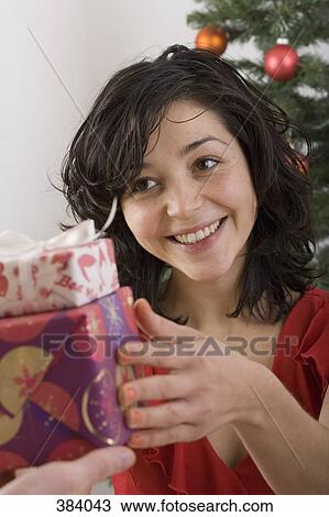 Woman exchanging presents at Christmas View Large Photo Image Stock Image - Woman exchanging presents at Christmas. Fotosearch