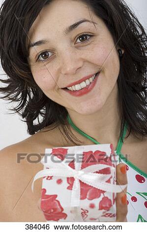 Woman holding present View Large Photo Image Stock Photograph - Woman holding present. Fotosearch