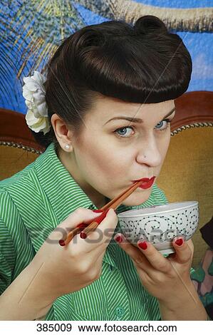 Close up of young rockabilly woman holding soup bowl and chopsticks View Large Photo Image Stock Photo - Close up of young rockabilly woman holding soup bowl and chopsticks. Fotosearch