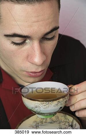 Stock Photo - Young rockabilly man drinking tea. Fotosearch