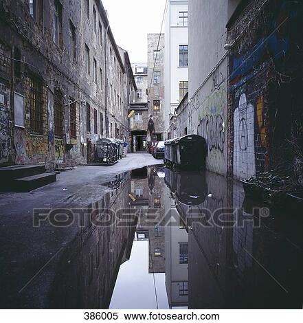 A large puddle and empty rubbish bins in an alleyway View Large Photo Image Stock Photography - A large puddle and empty rubbish bins in an alleyway. Fotosearch