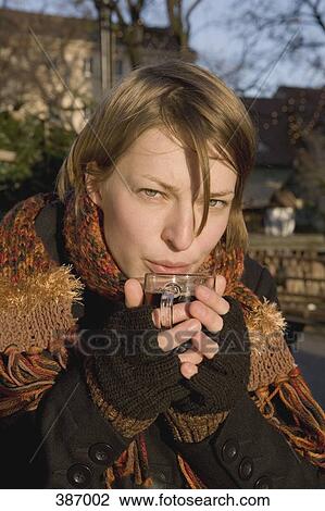 Woman holding a cup of mulled wine View Large Photo Image Stock Image - Woman holding a cup of mulled wine. Fotosearch