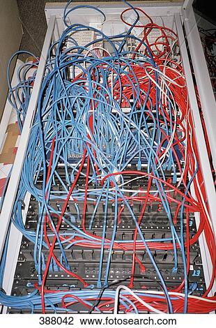 Stock Image - Cables connected to computer network server. Fotosearch
