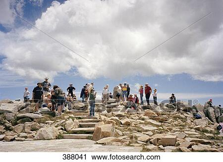 Crowd of people standing on rocky hill View Large Photo Image Stock Image - Crowd of people standing on rocky hill. Fotosearch
