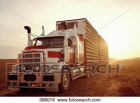 Semi-truck in remote landscape at sunset View Large Photo Image Stock Photo - Semi-truck in remote landscape at sunset. Fotosearch