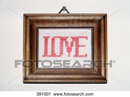 "Love" cross-stitching in a frame and hanging on a wall View Large Photo Image Stock Photo - "Love" cross-stitching in a frame and hanging on a wall. Fotosearch