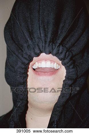 Stock Photography - Man wearing a black hood over his face. Fotosearch