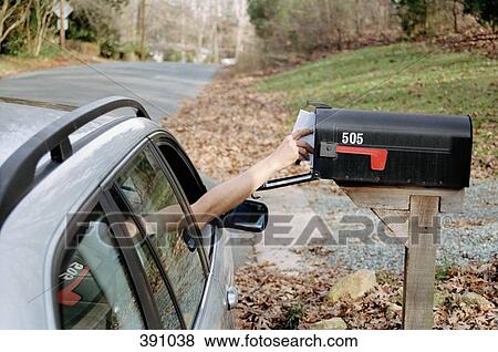 Stock Photo - Person reaching for letters in a mailbox. Fotosearch