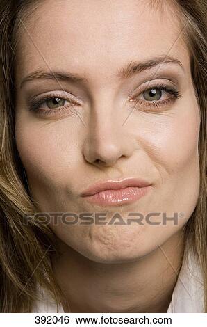 Close up of a woman looking uncertain View Large Photo Image Stock Photograph - Close up of a woman looking uncertain. Fotosearch