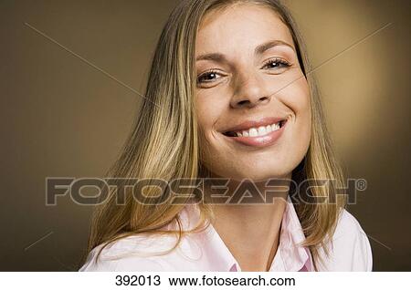 Stock Image - Portrait of woman smiling. Fotosearch