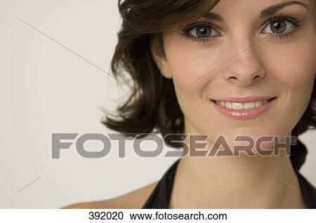 Stock Image - Portrait of woman smiling. Fotosearch