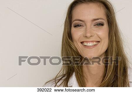 Stock Image - Portrait of woman smiling. Fotosearch