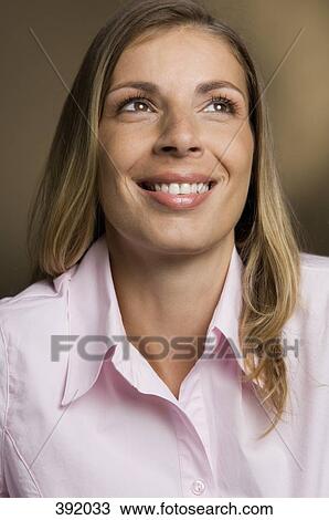 Stock Image - Portrait of woman smiling. Fotosearch