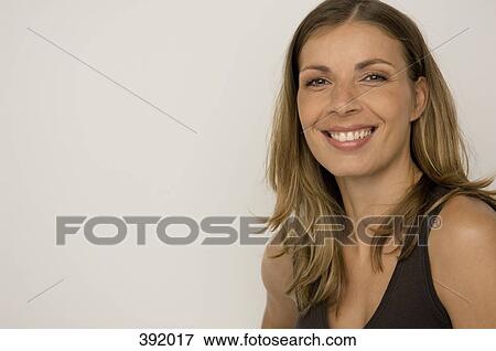 Stock Photo - Portrait of woman smiling. Fotosearch