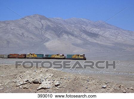 Freight train moving through barren landscape View Large Photo Image Stock Image - Freight train moving through barren landscape. Fotosearch