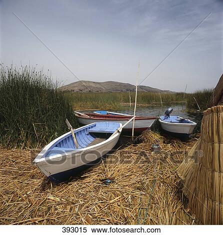 Stock Photography - Three boats aground on the shore of Titicaca Lake, Peru. Fotosearch
