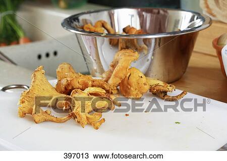 Chanterelle mushrooms on a chopping board View Large Photo Image Stock Image - Chanterelle mushrooms on a chopping board. Fotosearch