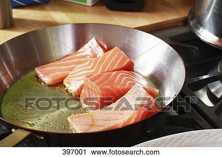 Stock Image - Fresh salmon frying in a pan. Fotosearch