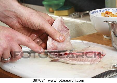 Man preparing raw fish View Large Photo Image Picture - Man preparing raw fish. Fotosearch