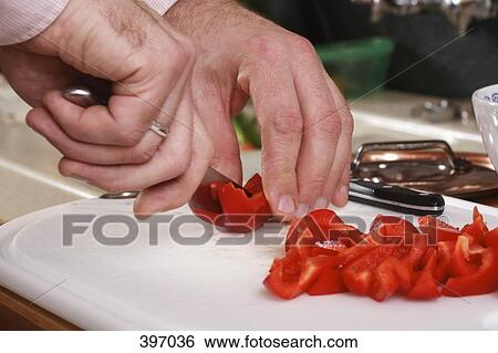 Stock Photograph - Man preparing vegetables. Fotosearch