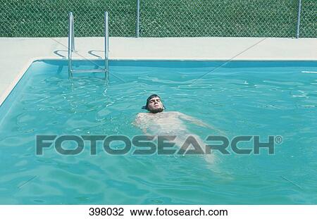 A man floating in an outdoor swimming pool View Large Photo Image Stock Image - A man floating in an outdoor swimming pool. Fotosearch