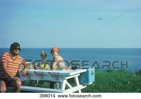 Family picnic on a ledge by the sea View Large Photo Image Picture - Family picnic on a ledge by the sea. Fotosearch