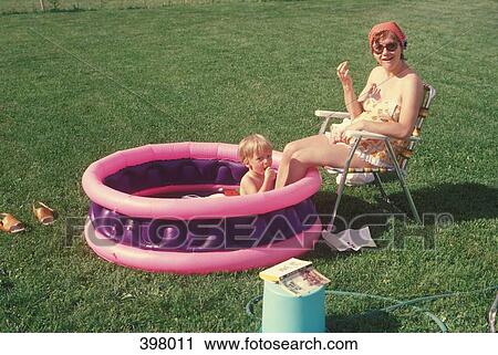 Mother and son together in a wading pool View Large Photo Image Stock Image - Mother and son together in a wading pool. Fotosearch