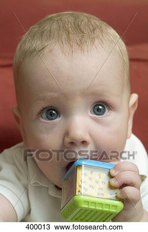 Close up of a baby with a toy View Large Photo Image Stock Image - Close up of a baby with a toy. Fotosearch