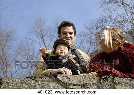 Family looking over a wall View Large Photo Image Stock Image - Family looking over a wall. Fotosearch