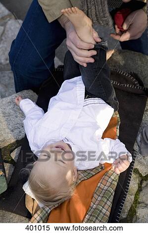Father dressing young boy outdoors View Large Photo Image Stock Photography - Father dressing young boy outdoors. Fotosearch