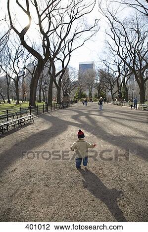 Young boy walking in park View Large Photo Image Stock Image - Young boy walking in park. Fotosearch