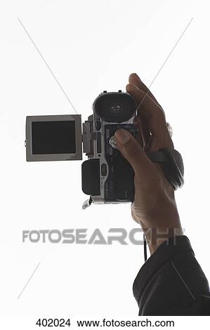 Hand holding a video camera View Large Photo Image Picture - Hand holding a video camera. Fotosearch