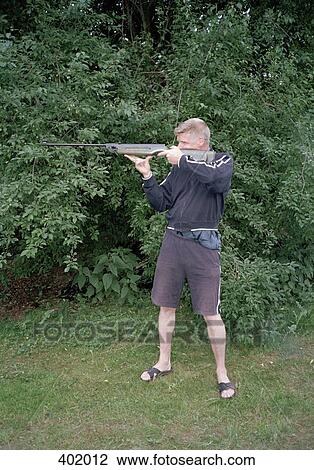 Man aiming a rifle View Large Photo Image Stock Image - Man aiming a rifle. Fotosearch