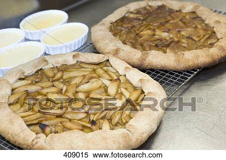 Apple tarts and dishes of creme brulee View Large Photo Image Stock Photography - Apple tarts and dishes of creme brulee. Fotosearch