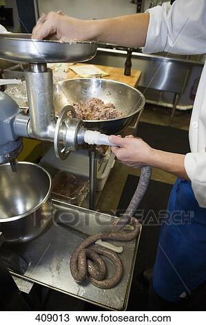 Man making fresh sausages in a commercial kitchen View Large Photo Image Stock Image - Man making fresh sausages in a commercial kitchen. Fotosearch