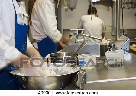 People working in an industrial kitchen View Large Photo Image Stock Image - People working in an industrial kitchen. Fotosearch