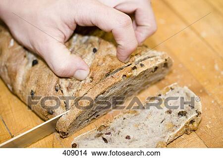 Person slicing stollen on a cutting board View Large Photo Image Picture - Person slicing stollen on a cutting board. Fotosearch