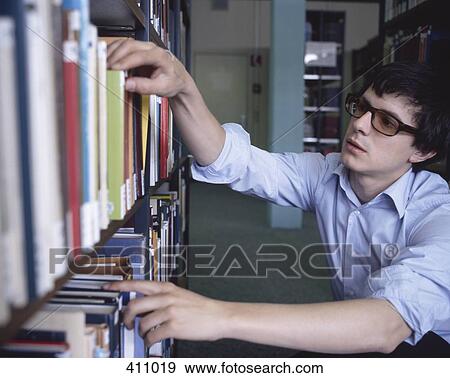 Stock Photo - Student for books in a library. Fotosearch