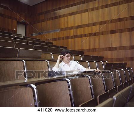 University student sitting in an empty lecture hall View Large Photo Image Stock Image - University student sitting in an empty lecture hall. Fotosearch