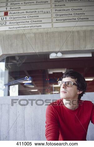 Stock Photography - University student sitting in the foyer of the science faculty building. Fotosearch