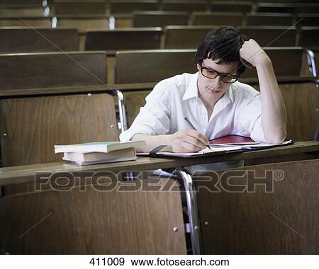 University student taking notes in a lecture theatre View Large Photo Image Stock Photo - University student taking notes in a lecture theatre. Fotosearch