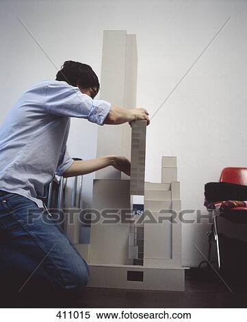 Stock Photography - Young man building an architectural model. Fotosearch