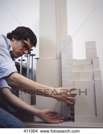 Young man working on an architectural model View Large Photo Image Picture - Young man working on an architectural model. Fotosearch
