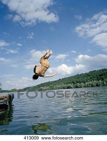 A young man doing a summersault into a lake View Large Photo Image Stock Photo - A young man doing a summersault into a lake. Fotosearch