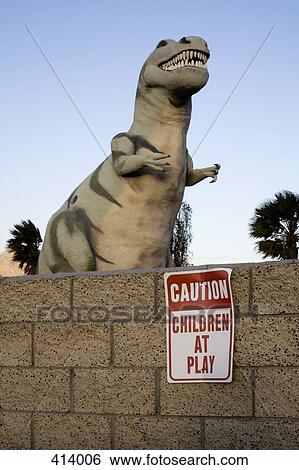 Stock Photograph - Dinosaur behind a wall. Fotosearch