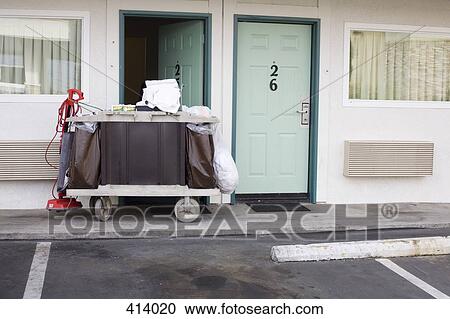 Stock Image - Maid trolley outside a motel. Fotosearch