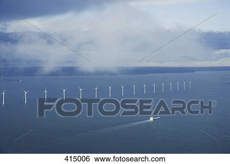 Stock Photograph - A row of wind turbines in the sea. Fotosearch