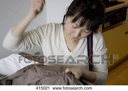 A woman sewing View Large Photo Image Stock Image - A woman sewing. Fotosearch